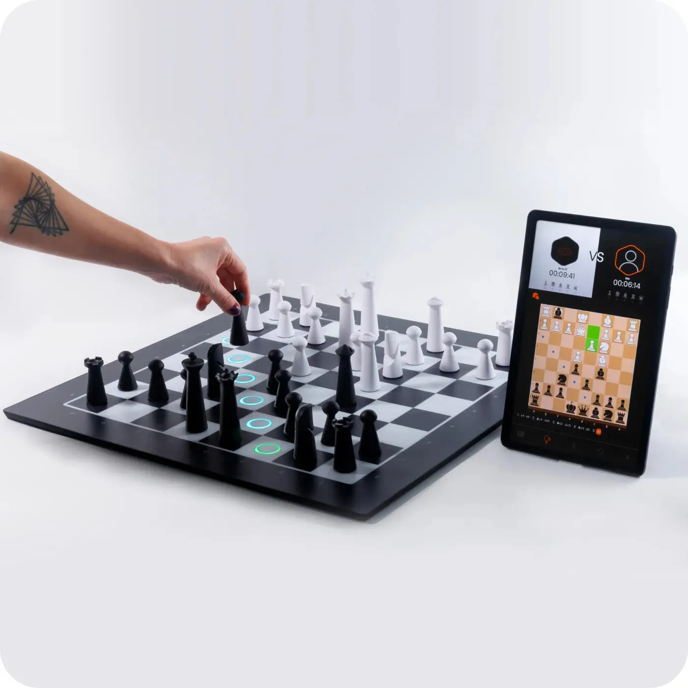 A player reaching for a piece on GoChess Pro Modern with the app on a tablet